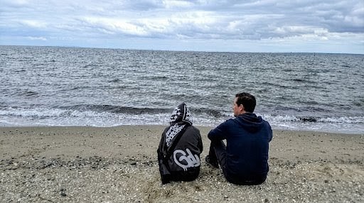 Sitting alongside, looking out at the ocean